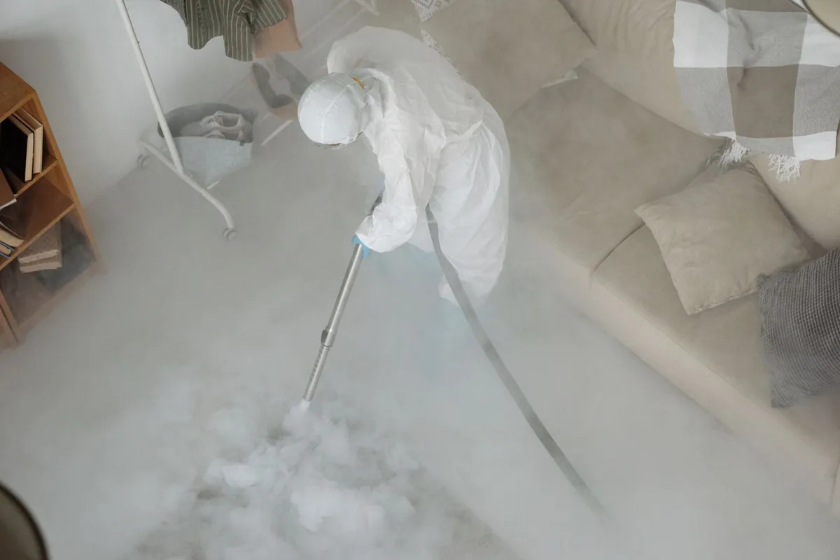 Biohazard cleanup technician in protective equipment, Bottineau, ND